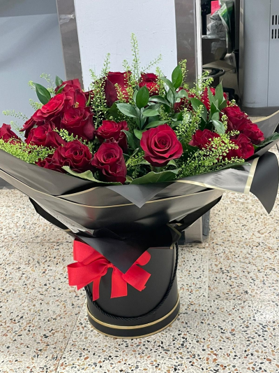 Ultimate Luxury Red Rose Box - A luxurious hatbox filled with 30 premium deep red roses, arranged with lush greenery in an elegant black hatbox with gold detailing and a bold red bow. The perfect romantic gift.