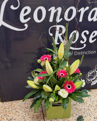 Pink Lily - A front-facing hand-tied bouquet in vibrant pink and fresh green tones, beautifully arranged to create a striking gift for any special occasion.